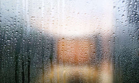 Background with rain drops on glass, closeup view. Rainy weather