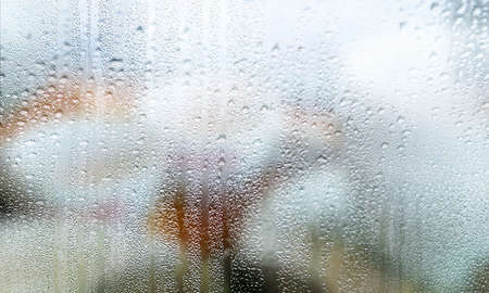 Condensation on the window. Rain drops on the glass. Abstract background.