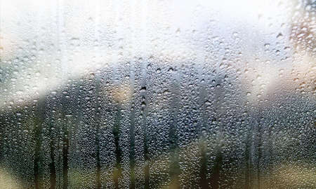 Condensation on the window. Water drops on the glass. Rainy weather.