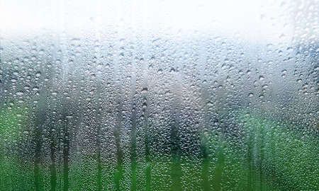 Rain drops on window glass close up. Raindrops on window glass closeup. Natural background.