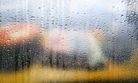 Drops of rain on the window, close-up, blurred background