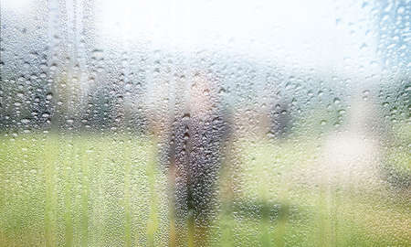 Rain drops on the window, blurred background with copy space for text