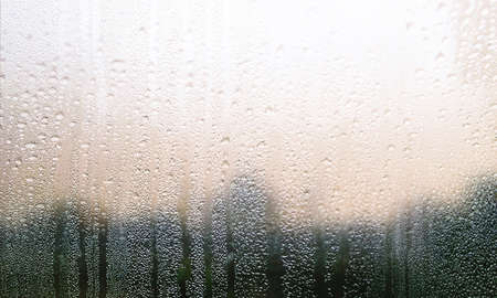 Condensation on the window. Water drops on the glass. Rainy weather.の写真素材