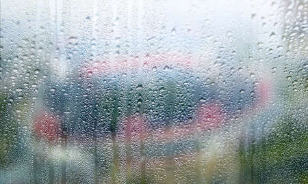 Rain drops on the window, blurred background. Raindrops on the window, blurred background.