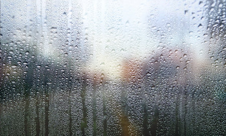 Rain drops on window glass, closeup. Rainy weather background