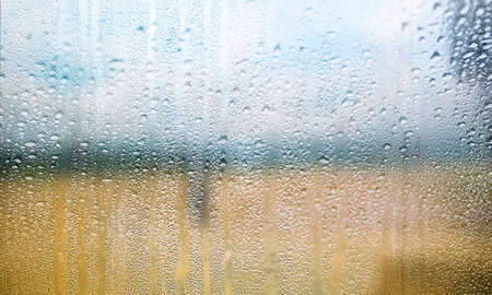 Water drops on window glass. Rainy weather background. Close up.の写真素材