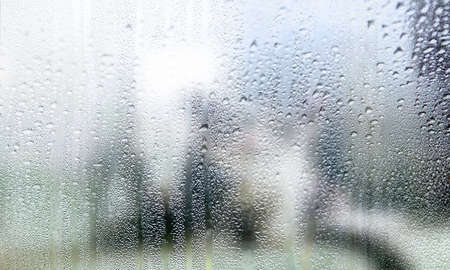 Water drops on the glass, blurred background. Rainy day.