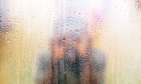 Condensation on the window, blurred background. Rainy weather.の写真素材