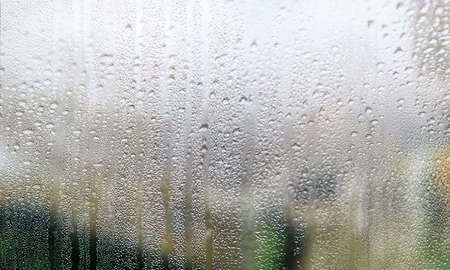 Condensation on the window. Water drops on the glass. Rainy weather.