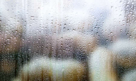 Drops of rain on the window, rainy day, blurred background