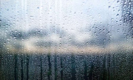 Condensation on the window. Raindrops on the glass. Rainy weather.