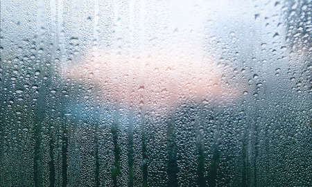 Condensation on the window. Water drops on the glass. Rainy weather.