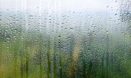 Water drops on window glass. Rainy day, natural background.