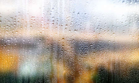 Water drops on the glass with blurred background. Condensation on the window, close-up