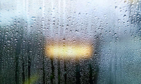 Condensation on the window. Water drops on the glass. Rainy weather.