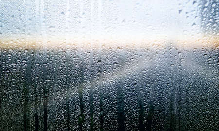 Condensation on the window glass, natural background. Rainy weather.