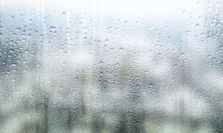 Drops of rain on the window. Rainy day, blurred background.