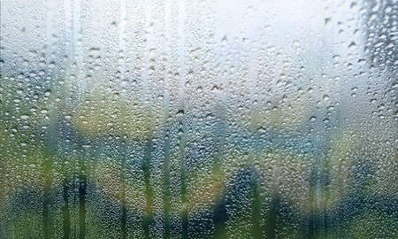 Drops of rain on the window, close-up. Natural background