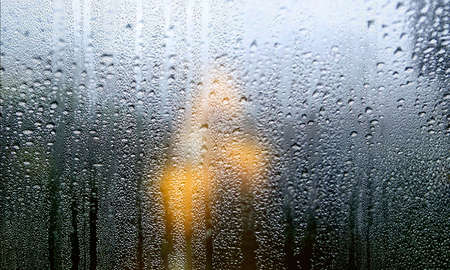 Condensation on the window. Raindrops on the glass. Rainy day.