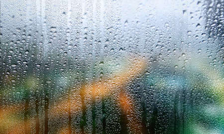 Drops of rain on the window. Rainy weather background.
