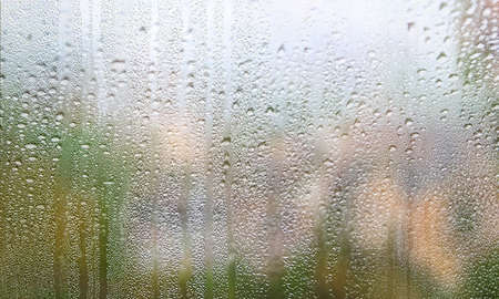 Condensation on the window. Raindrops on the glass. Rainy weather.