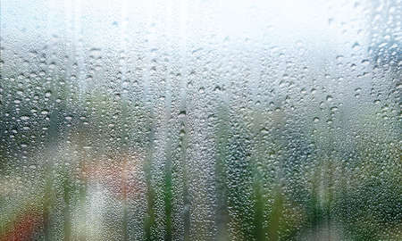 Background with rain drops close up. Rain drops on outdoor window, shallow DOF