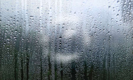 Condensation on the window. Water drops on the glass. Rainy weather.
