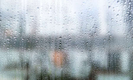Condensation on the glass. Rain drops on the window, blurred background.の写真素材