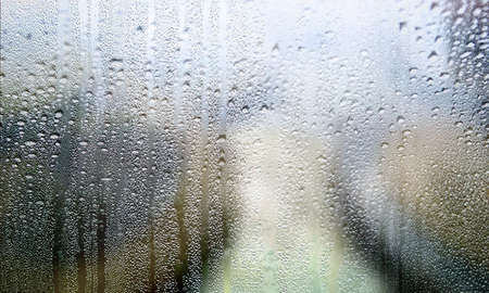 Water drops on glass background, condensation on window, closeup view. Rainy weather