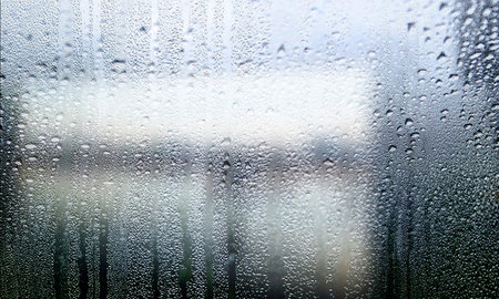Water drops on the window glass. Rainy weather, natural background