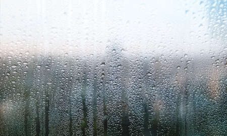 Condensation on the window. Water drops on the glass. Rainy weather.