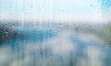 Water drops on window glass background, closeup view. Rainy weather