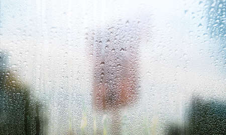 Condensation on the window. Water drops on the glass. Rainy weather.