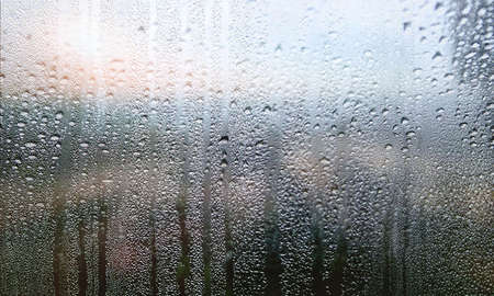 Condensation on the window. Water drops on the glass. Rainy weather.の写真素材