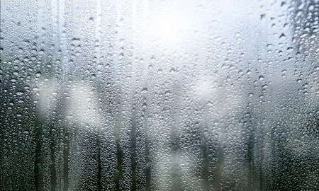 Water drops on window glass. Rainy weather. Natural background.