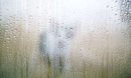 Condensation on the window glass. Rain drops on the window.の写真素材