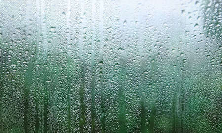 Water drops on window glass. Rain drops on window glass background.