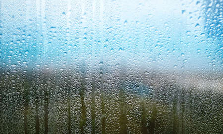 Water drops on window glass in rainy day, closeup. Rainy weather
