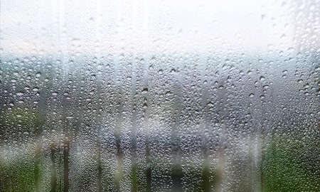 Water drops on the glass. Raindrops on the window. Rainy weather.