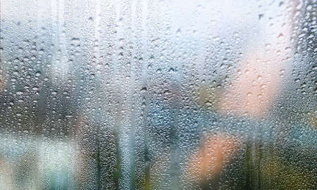Condensation on the window. Water drops on the glass. Rainy weather.