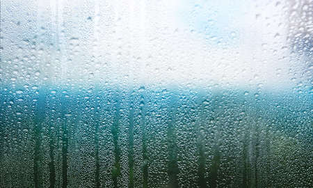Rain drops on window glass, closeup view. Rainy weather