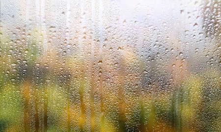 Rain drops on window glass, closeup view. Rainy weather