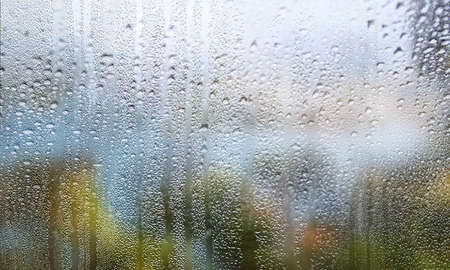Condensation on the window. Water drops on the glass. Rainy weather.