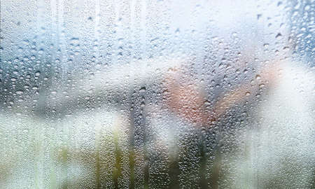Rain drops on window glass, closeup view. Rainy weather
