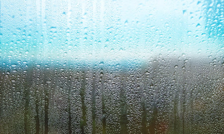 Rain drops on window glass, closeup view. Rainy weather