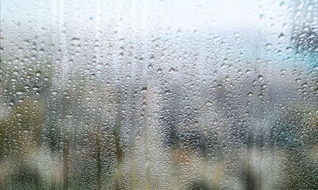Condensation on the window in rainy weather, close-up.