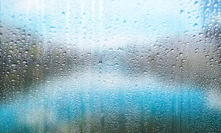 Background with rain drops on glass, closeup view. Rainy weather