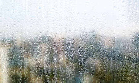 Drops of rain on window glass close-up. Rain drops on window glass surface close-up. Rain drops on...