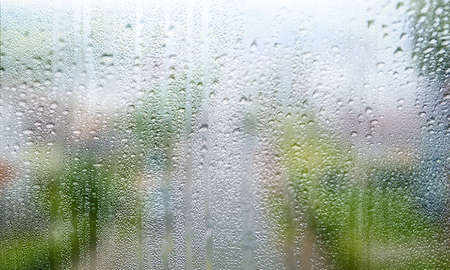 Background with rain drops on glass close up. Rain drops on outdoor window, humid water backdrop,...