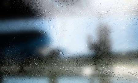 Drops of rain on the window, close-up, blurred background